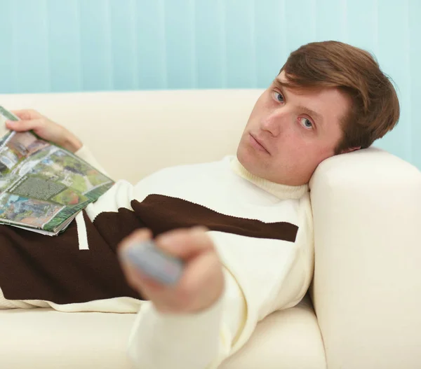 Young Man Lying Couch Magazine Remote Control — Stock Photo, Image