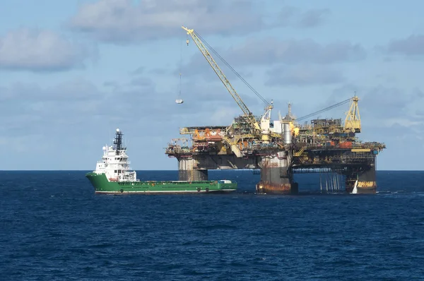 Supply vessel and oil rig in offshore area during supply transfering operation.  Coast of Brazil, 2011.