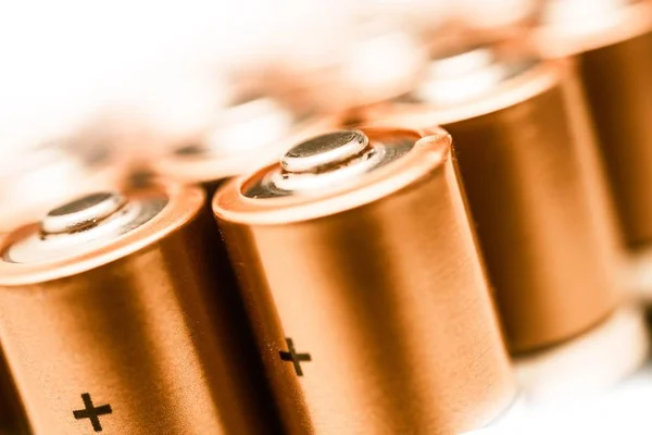 AA Batteries Closeup on a White Background. Batteries Technology. Power Industry.