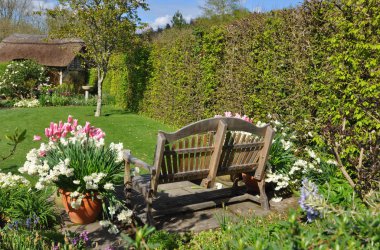 Garden furniture an English style garden. Taken at RHS Rosemoor, Torrington, North Devon, England clipart