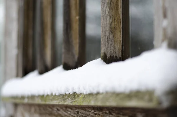 木製の窓枠の底に雪が落ち着いた — ストック写真