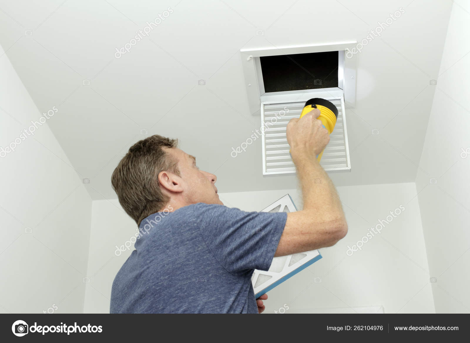 Man Inspecting Air Ducts Shining Flashlight Small Square