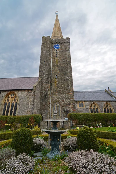 嵐の空に対する教会の尖塔と庭園 — ストック写真