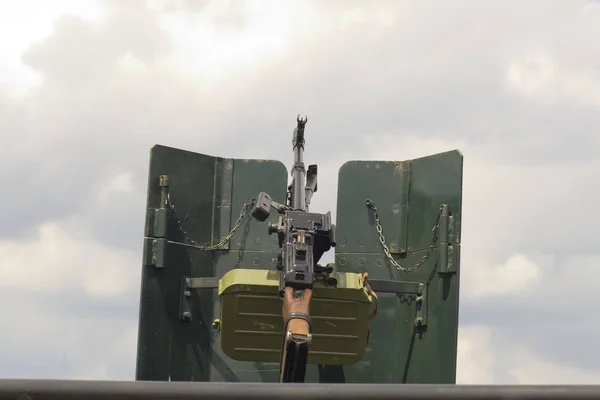 Military machine gun mounted on vehicle