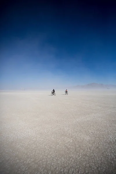 Cyclists riding mountain bikes in the Black Rock Desert in Nevada, USA