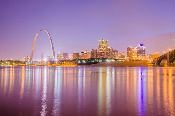 City of St. Louis skyline. Image of St. Louis downtown with Gateway Arch at twilight.
