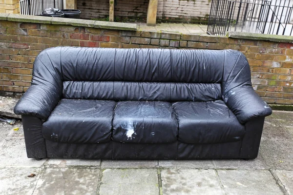 Rejected old sofa waiting for bulky waste collection