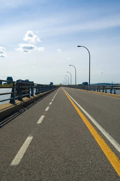 A bicycle lane on a very long bridge, portrait orientation