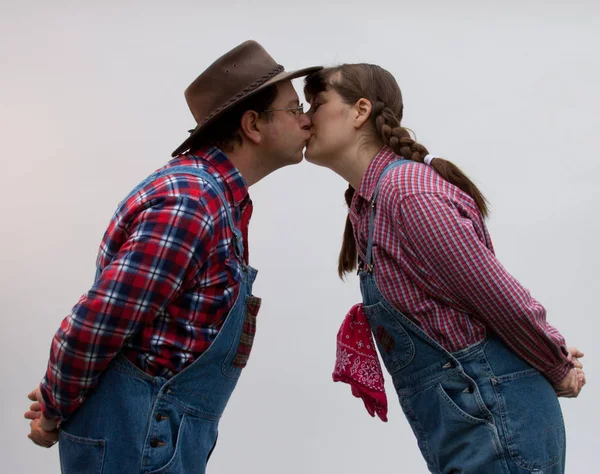 Two farmers or country people kissing.