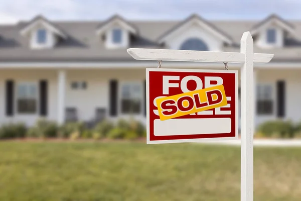 Red Sold For Sale Real Estate Sign in Front of House.