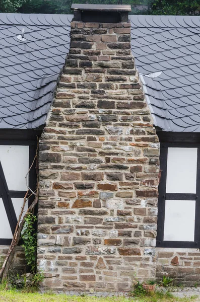 Chimney or natural stone fireplace and dry stone made.