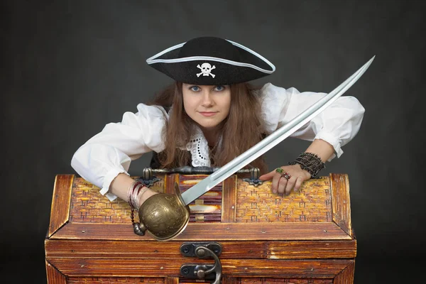 Woman the pirate with a sabre and chest with treasures
