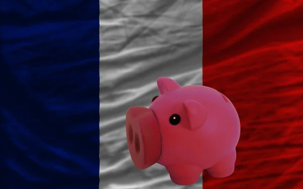 Piggy rich bank in front of national flag of france symbolizing saving and accumulating funds as good financial habit