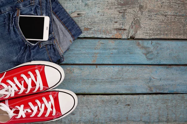 Red Retro Sneakers Smartphone Jeans Pocket Blue Wooden Background — Stock Photo, Image