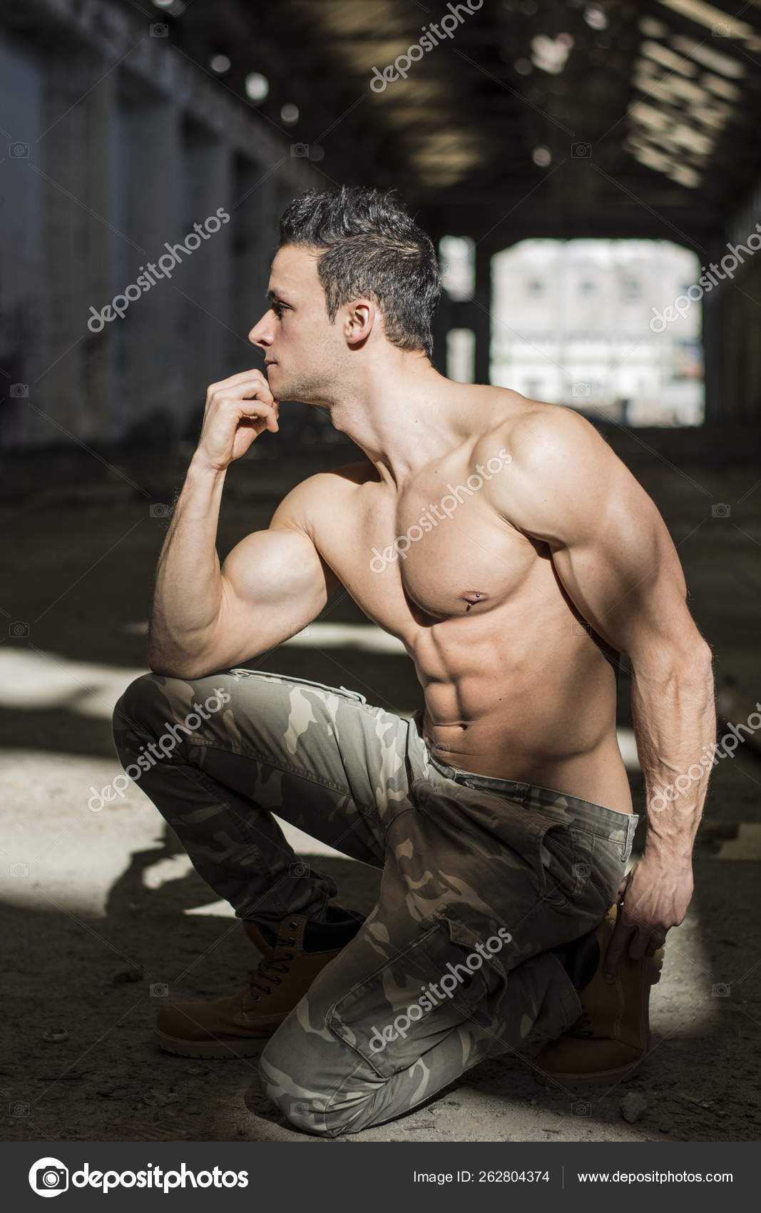 Profile Muscular Shirtless Young Man Abandoned Warehouse Kneeling Looking  Away Stock Photo by ©YAYImages 262804374