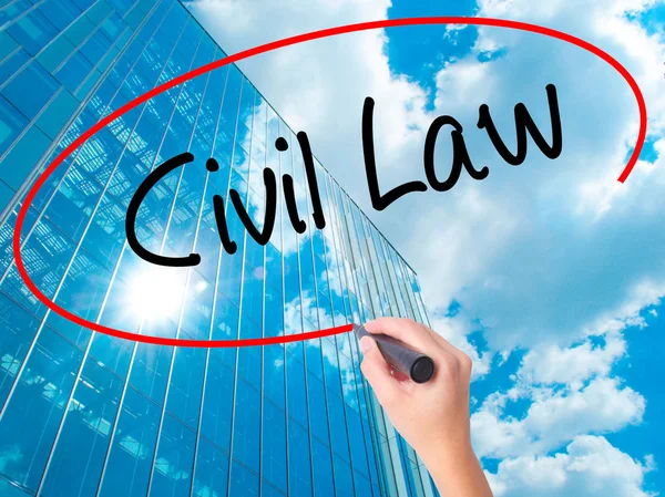 Women Hand writing Civil Law with black marker on visual screen. Isolated on skyscraper. Business, technology, internet concept.