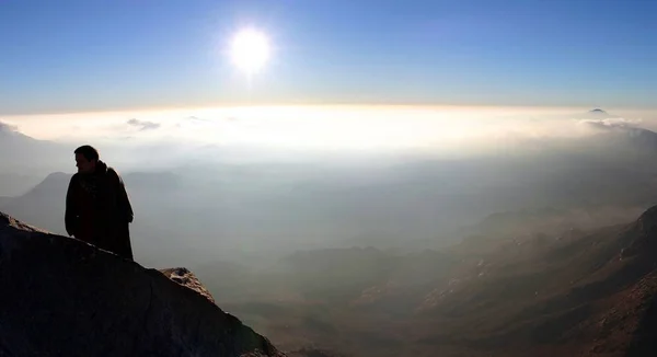 Man standing and looking at the Barren mountains around Mount Sinai, Egypt