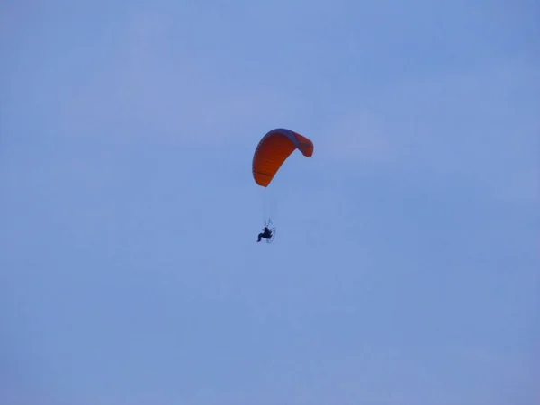 This is a man in motor hang glider.