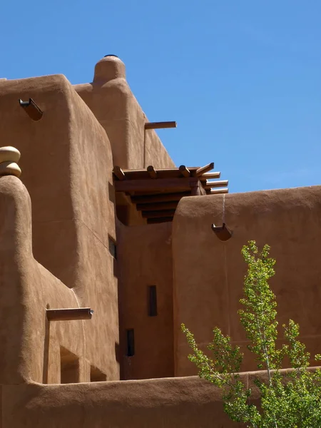 Adobe building with flat roof drainage system.