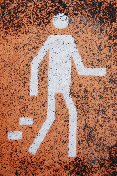 Señal Tráfico Peatonal Blanca Pintada Sobre Una Superficie Asfalto Naranja — Foto de Stock