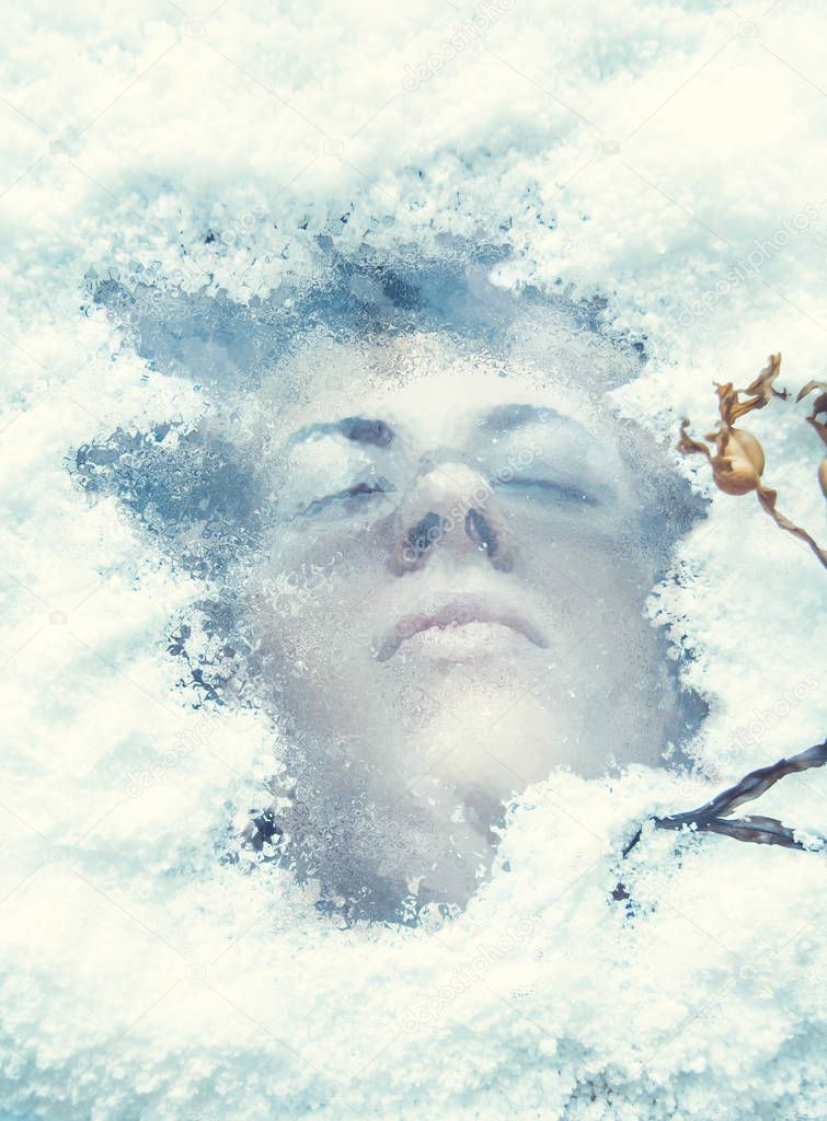 Portrait of a woman in under the ice around the snow