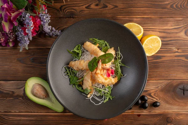 Tempura karides tartar sosu ahşap arka plan üzerinde siyah bir tabakta ile