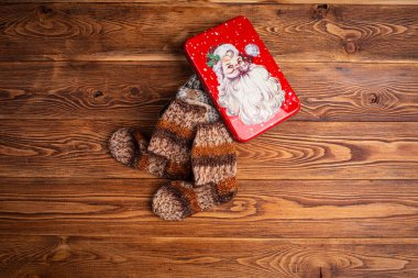 çok renkli örme Bebek çorap ve ahşap bir arka planda Noel Baba görüntüsü ile metal bir kutu