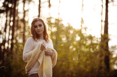 güneşli bir günde sonbahar orman bir arka plan üzerinde parlak giysiler içinde kızıl saçlı kız