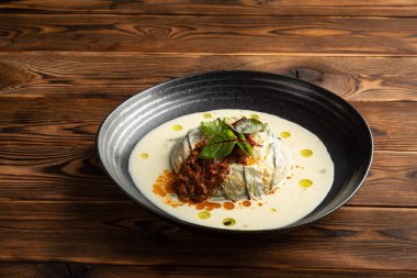 siyah bir tabakta ıspanak ve parmesan süt ile sıcak patlıcan