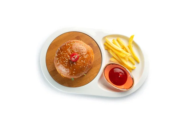 Hamburger, french fries and tomato sauce in a white oval plate isolated on white background — Stock Photo, Image