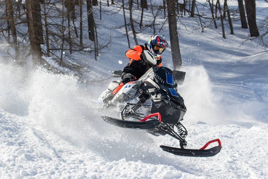 men in action with snowmobile