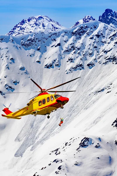 rescue helicopter with rescuer at the winch
