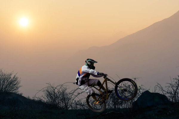 biker at sunset - soaring with mtb