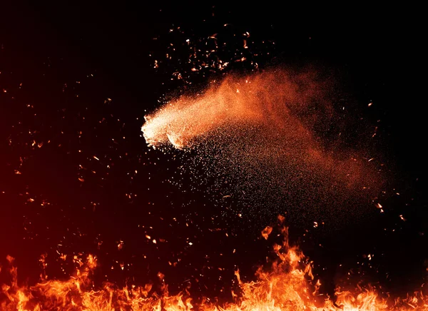 Explosion powder . Fire particles debris isolated on black background for text or space . Film effect.