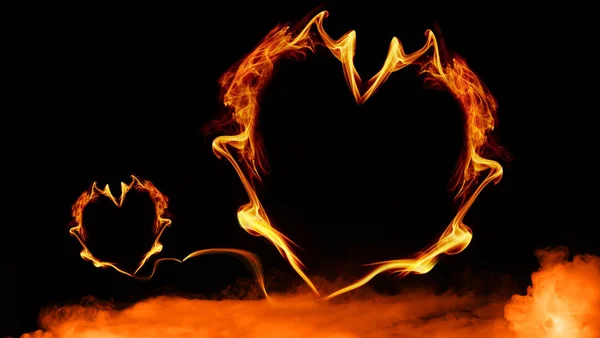 Fire hearts on isolated smoke black background. Hearts shape with copyspace.