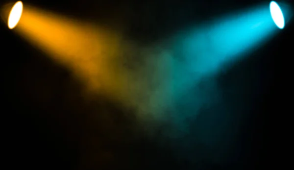 Colorful projector. Spotlight stage with smoke on black background.