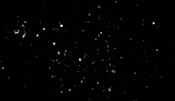 Стоп движения белого снега спускается вниз, изолированный на черном фоне. Элемент текстуры . — стоковое фото