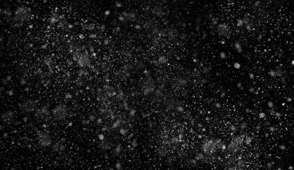 Primera caída de nieve bokeh textura sobre fondo negro. Textura invierno . —  Fotos de Stock