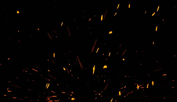 Particelle di fuoco effetto polvere detriti isolati su sfondo nero, polvere di movimento spruzzo scoppio . — Foto Stock