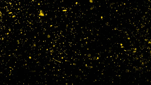 Yellow particles effect dust debris isolated on black background, motion powder spray burst in dark texture