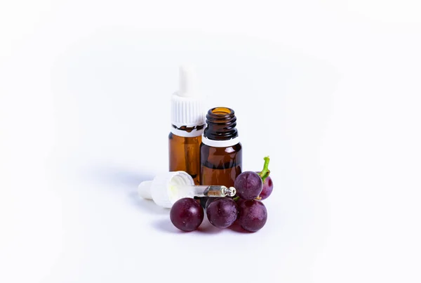 Aísla racimo de uvas con una botella de aceite sobre un fondo blanco — Foto de Stock