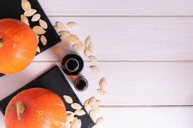 Ahşap arka planda çekirdekli cam şişeler ve balkabağı manzarası