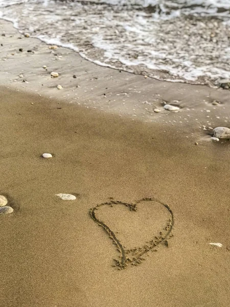 Heart drawn to waves and Sands drawn by the sea shore