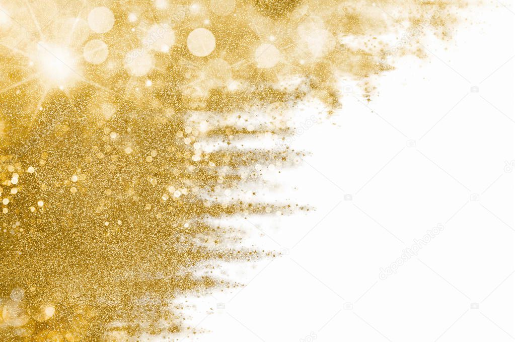 Golden Christmas background with sparkling and twinkling bokeh, gold glitter over white with copyspace for your seasonal greetings. Festive abstract gilt background.