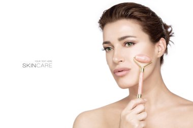 Spa woman using rose quartz face roller on her fresh clean skin. Facial treatments clipart
