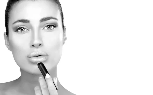 Monochrome beauty model applying lipstick to her lips isolated o — Stock Photo, Image