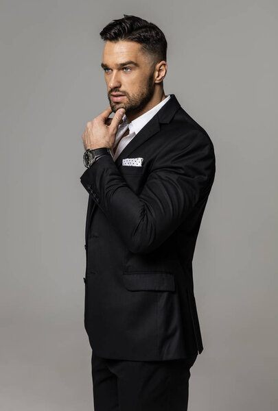 Handsome man wear classic black suit and thinking 