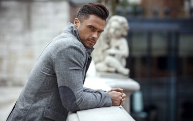Portrait of handsome man in gray stylish jacket 