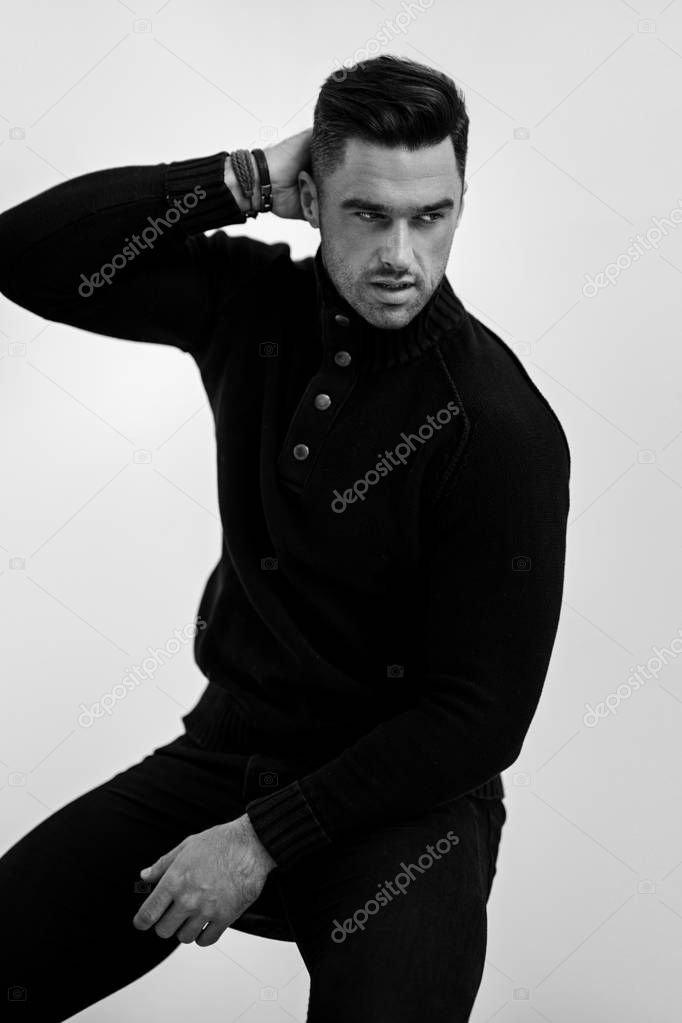 Portrait of handsome man in black turtleneck jumper isolated on white background
