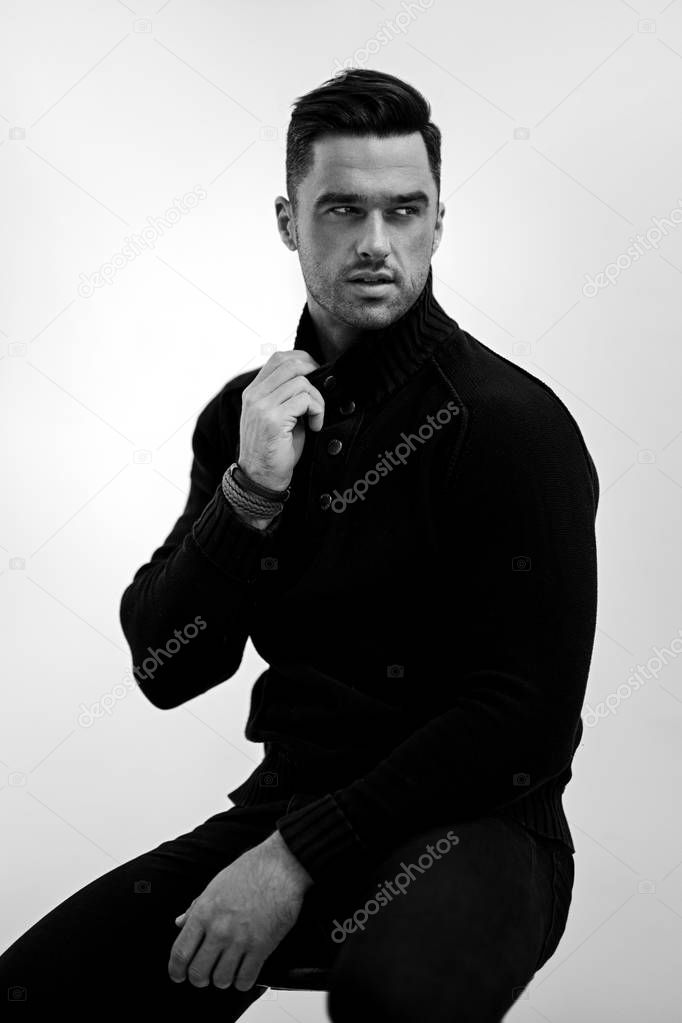 Portrait of handsome man in black turtleneck jumper isolated on white background